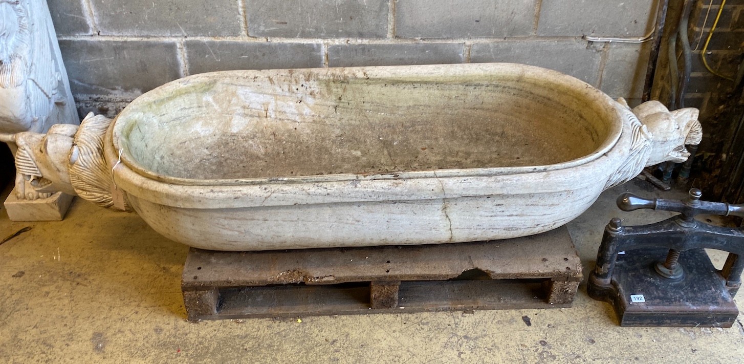 A South East Asian carved stone trough with twin lion mask decoration, width 184cm, depth 61cm, height 30cm